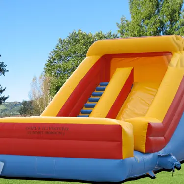 Inflatable slide with safety barriers